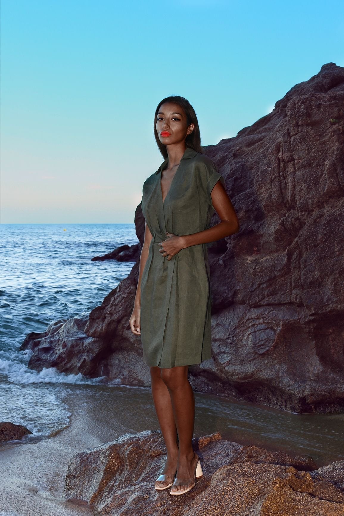 Green wrap linen formal dress with a V-neckline and fitted waist.