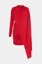 Stylish red minidress featuring a loose-fitting bodice and a graceful cape detail.