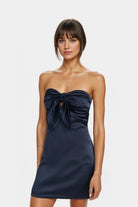 Chloe Tie-Front Satin Mini Dress in navy showcasing a beautiful sweetheart neckline.