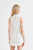 Elegant white dress featuring a fitted silhouette and modern design.