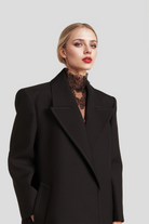 Clara Black Virgin Wool Coat featuring a sophisticated midi-length design and elegant oversized flap.