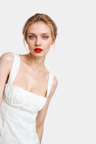 Stylish off-white linen dress with a flared silhouette, perfect for summer occasions.