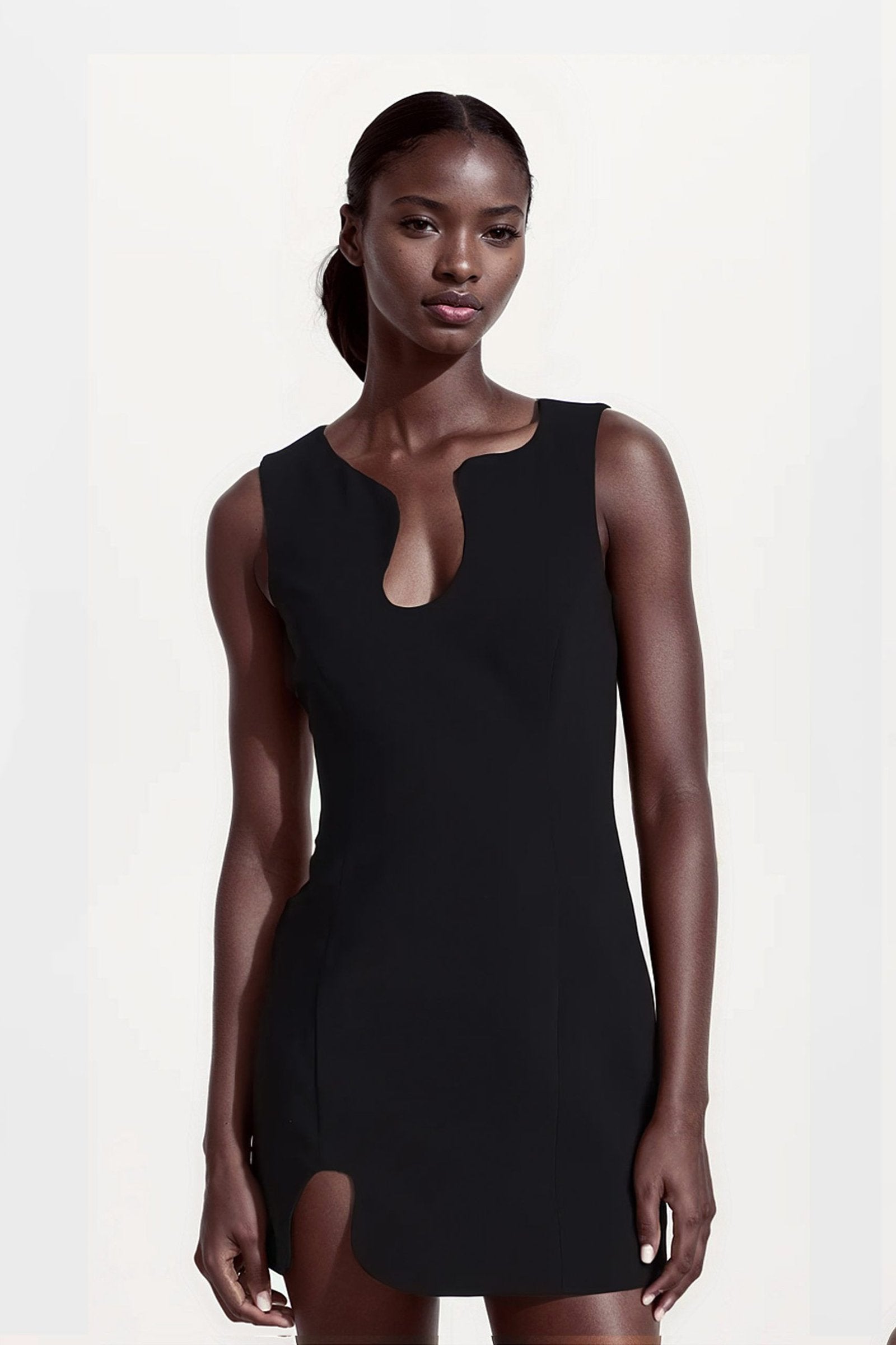 Asymmetric black mini dress with a unique puzzle-inspired design