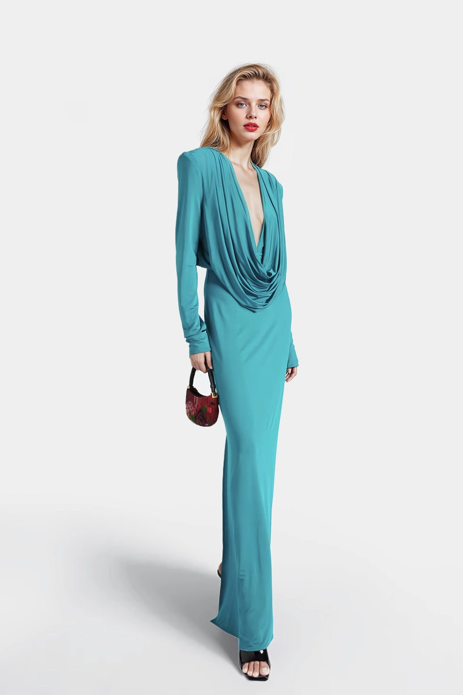 Long green jersey dress featuring a cascading pleat neckline.