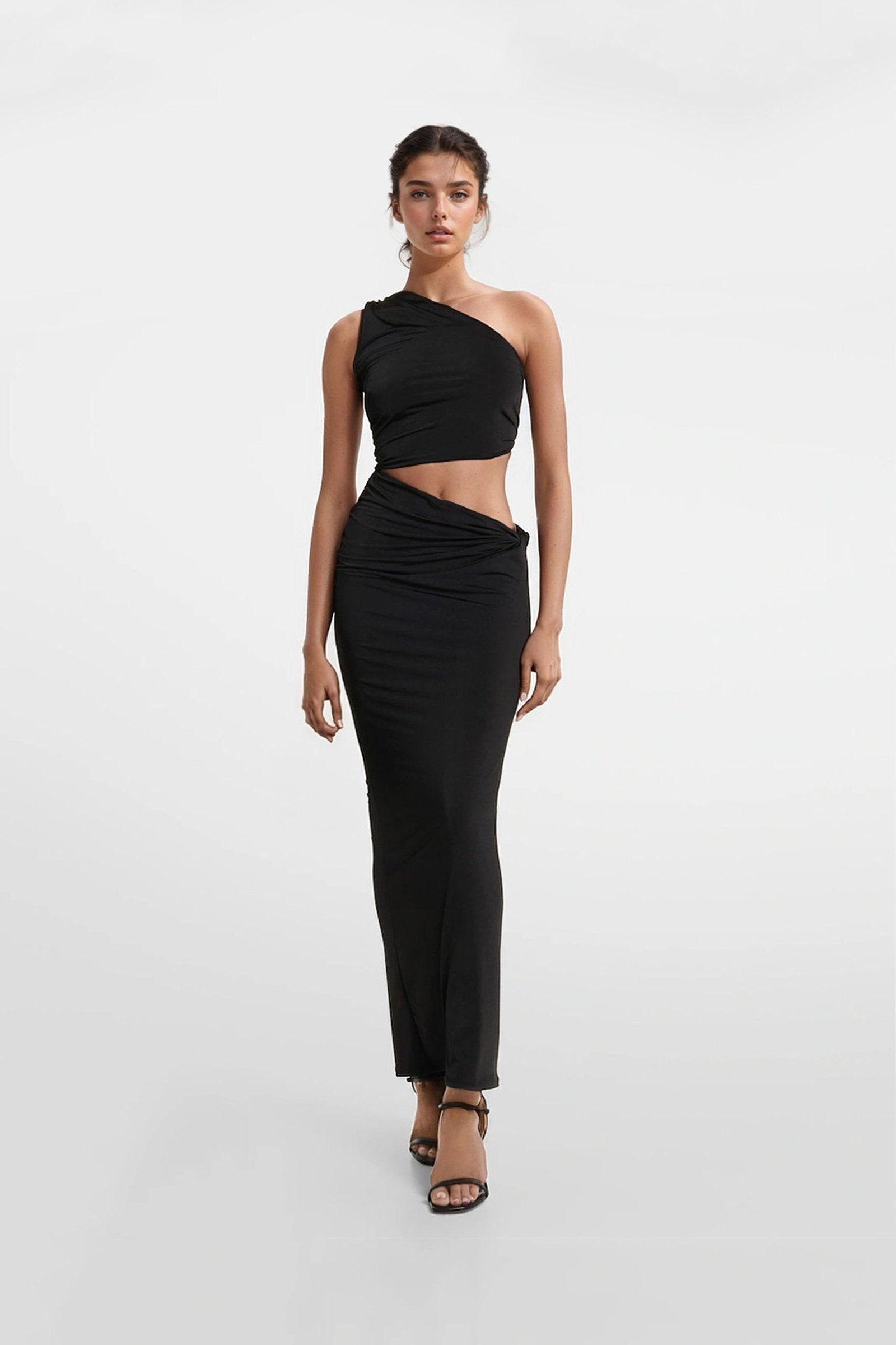 Fitted black jersey dress featuring an asymmetric skirt and ruching.