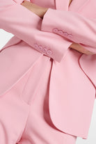 Julie Single-Breasted Crepe Blazer in pink with oversized shoulders and cinched waist.