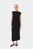 Elegant black midi dress featuring a round neckline and on-seam hip pockets.