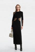 Fitted long-sleeve black dress with a back zip closure and luxurious crepe fabric.