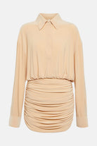 Elegant ruched shirt mini dress in beige with fitted silhouette.