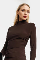 Elegant brown jersey midi dress with turtleneck and asymmetrical hem.