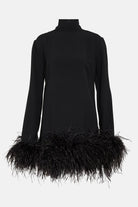 Stylish turtleneck mini dress featuring feather detailing at the hem