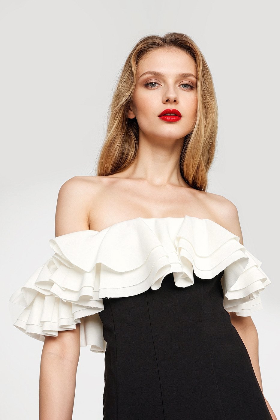 Chic black mini dress featuring layers of ruffles and an off-shoulder neckline.