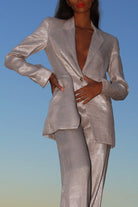 Tailored organic linen blazer with exaggerated shoulders for a chic look.