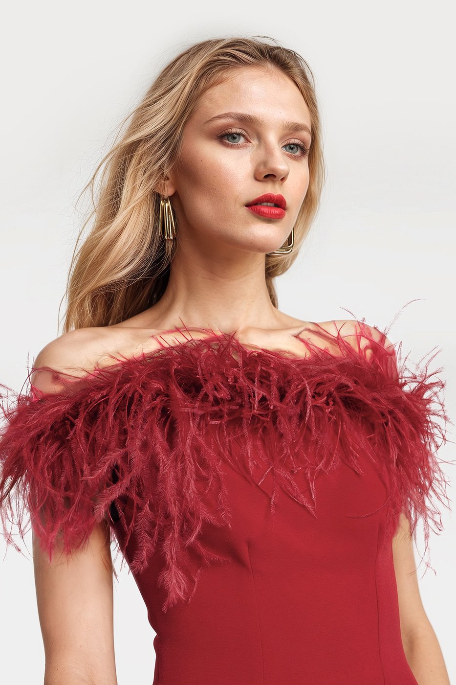 Chic red midi dress featuring a feather trim and stylish slits in the back.