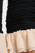 Luna Ruched Mini Dress in black with cream cuff trim and elegant ruching.