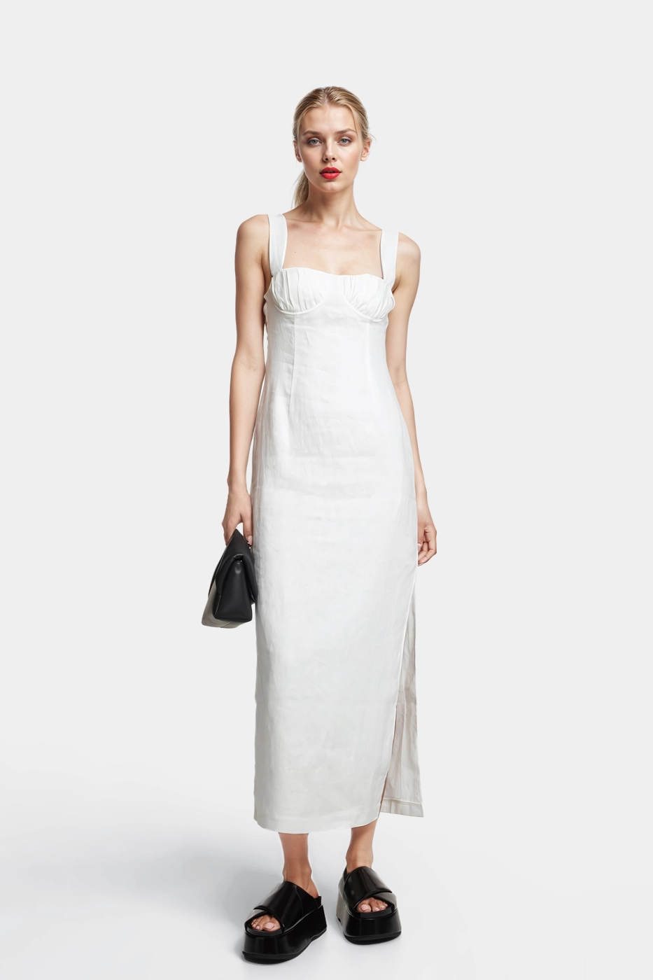 The Lucy midi dress is made of linen in off-white color. The dress has a flared line with a draped bustier