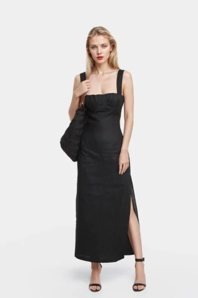 The Lucy midi dress is made of linen in black color. The dress has a flablack line with a draped bustier